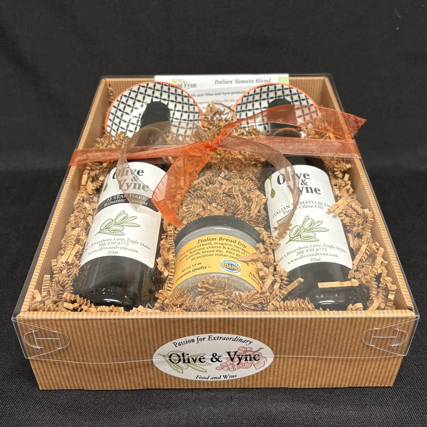 Bread dipping gift set with 25 Star Dark Balsamic and Italian Tomato Fused Olive Oil in a clear-lidded box with coordinated ribbon.