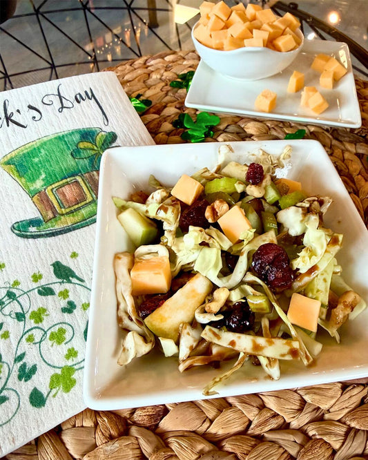 Lucky Crunch Chopped Salad made with cabbage, romaine, green apple, cheddar, walnuts, and dried cranberries, topped with a Black Walnut Balsamic vinaigrette.