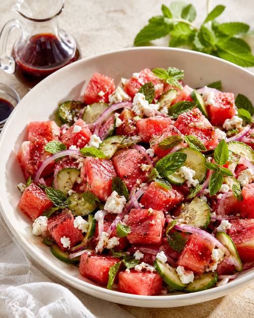 Watermelon and feta salad with cucumbers, red onions and fresh herbs