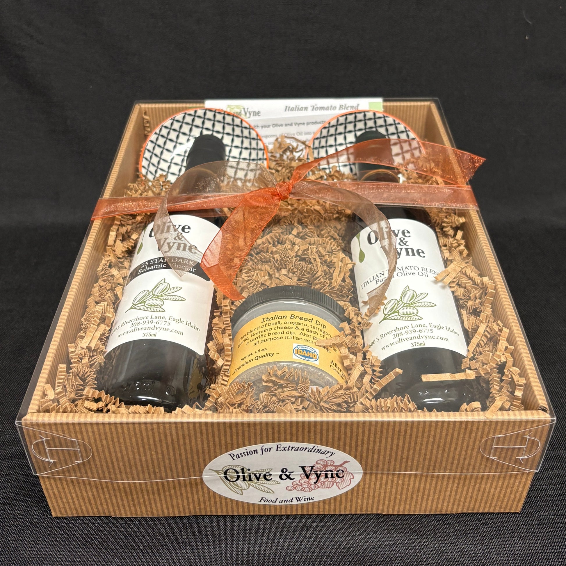 Bread dipping gift set with 25 Star Dark Balsamic and Italian Tomato Fused Olive Oil in a clear-lidded box with coordinated ribbon.