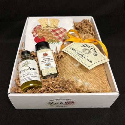 Open 9x12 Breadstick Mix gift box with Dr. Pete’s Grissini Mix, Italian Tomato Blend Olive Oil, Cheesy Garlic Blend, and embroidered cotton towel.