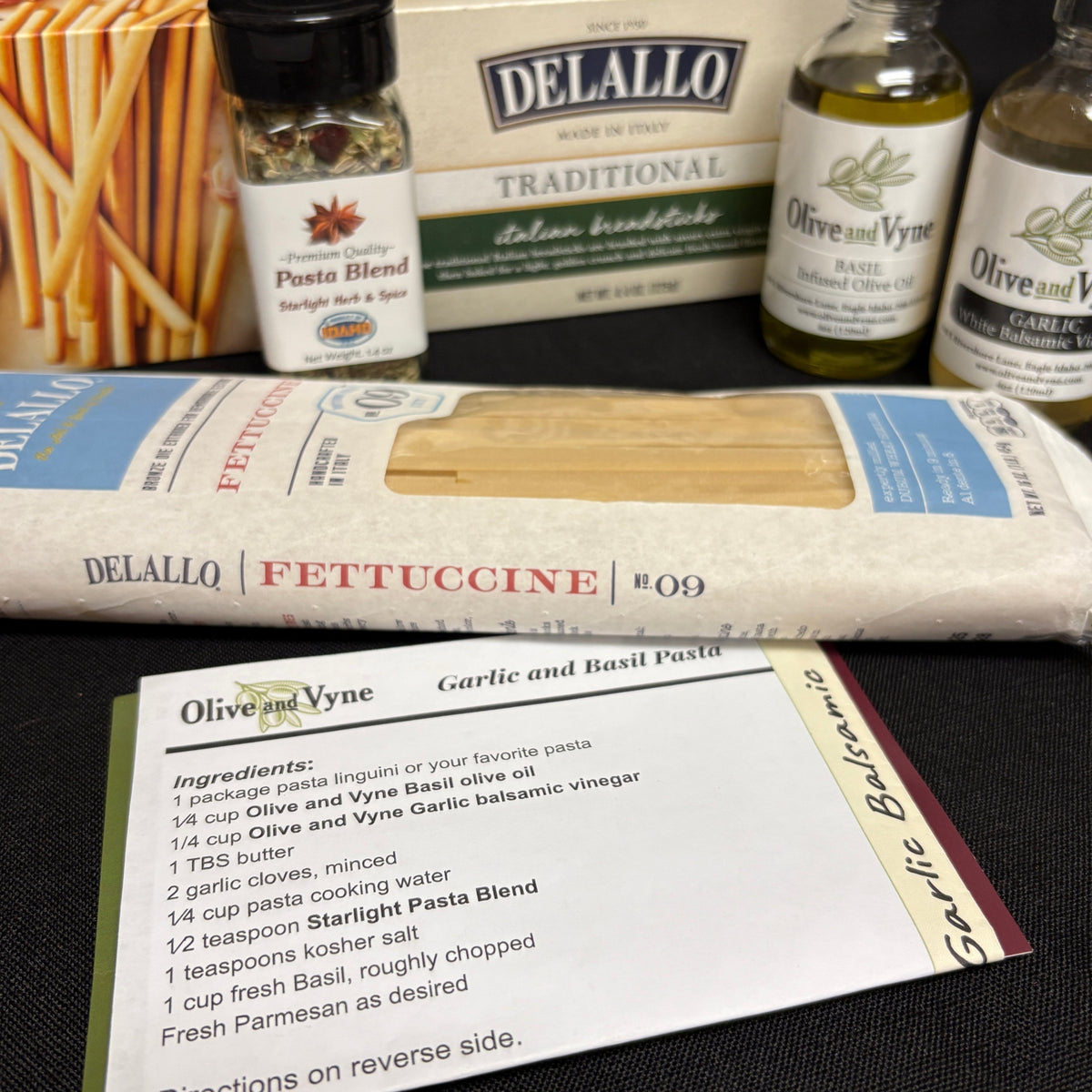 Basil and Garlic pasta recipe card with DeLallo fettuccine, breadsticks, Olive & Vyne oils, and Starlight Pasta Blend.