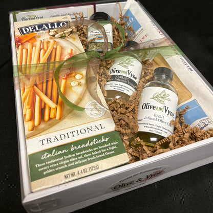 9x12 Garlic & Basil pasta gift box with Olive & Vyne oils, DeLallo pasta and breadsticks, Pasta Blend seasoning, recipe card, and coordinated ribbon.