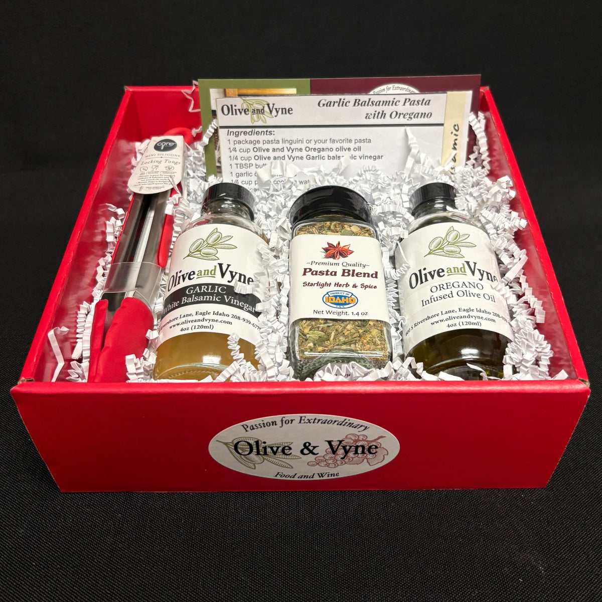 Open Garlic Balsamic & Oregano pasta gift box with Olive & Vyne products, Pasta Blend seasoning, mini tongs, and recipe card.