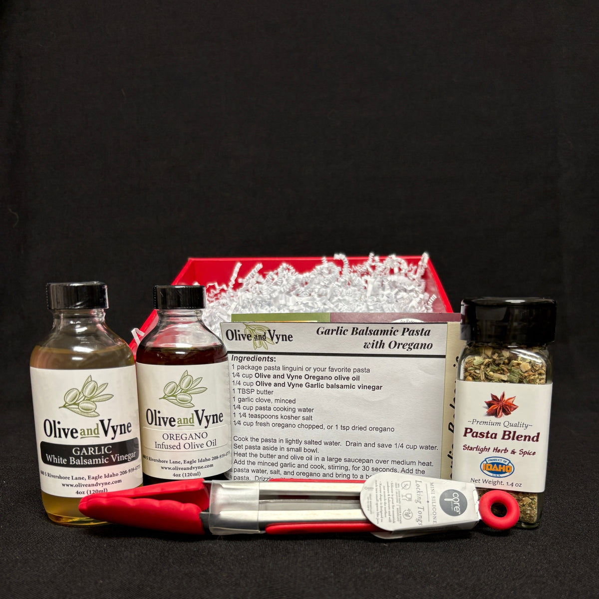 Garlic White Balsamic, Oregano Infused Olive Oil, Pasta Blend seasoning, mini locking tongs, and pasta recipe card.