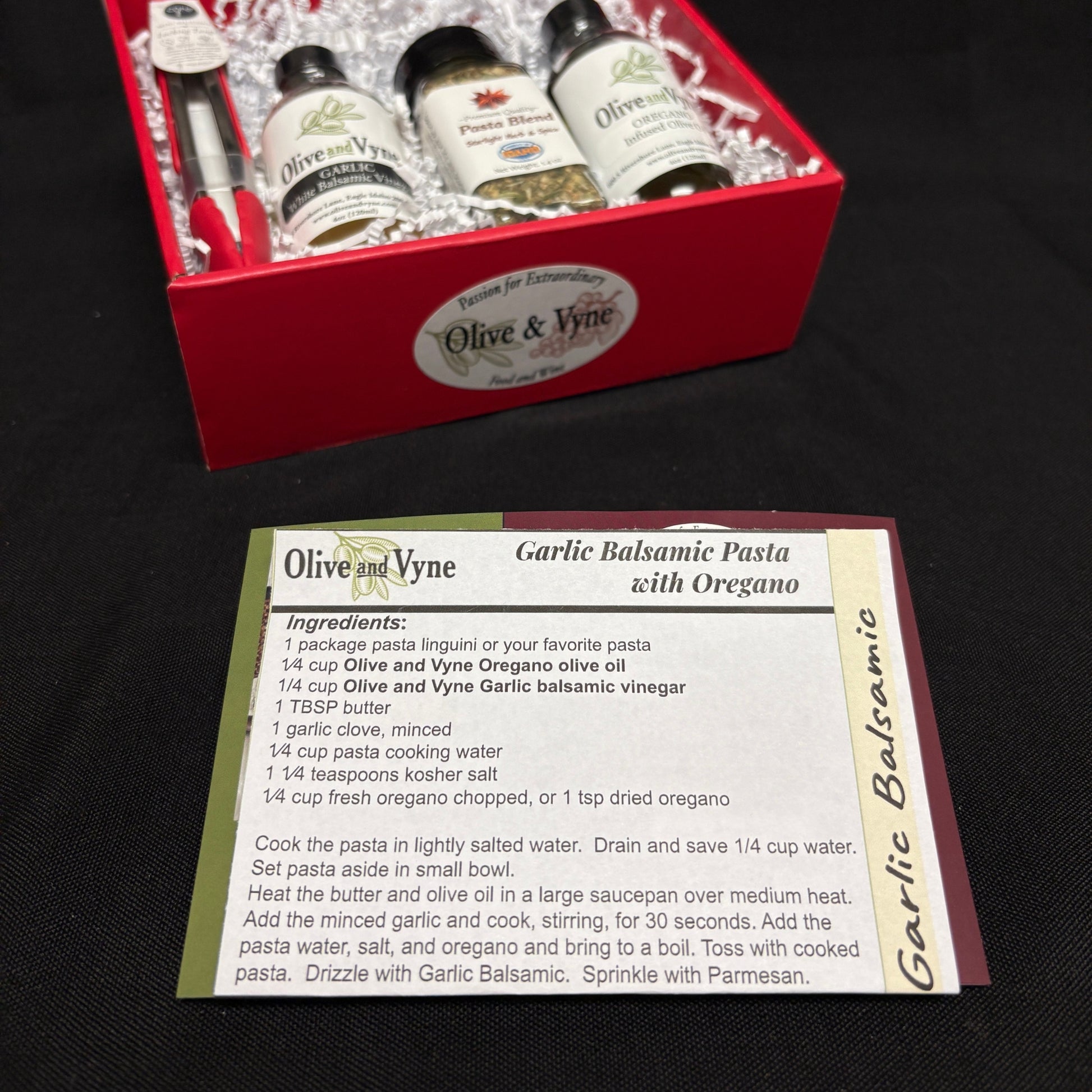 Garlic Balsamic Pasta with Oregano recipe card beside the featured Olive & Vyne products and Pasta Blend seasoning.