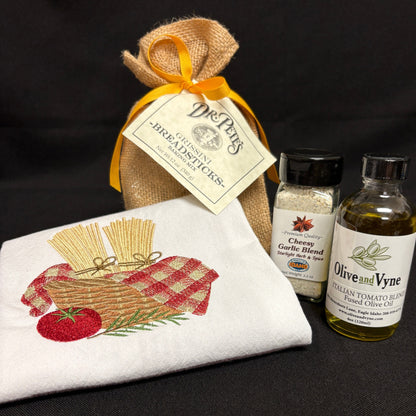 Dr. Pete’s Grissini Breadsticks Baking Mix with Italian Tomato Blend Fused Olive Oil, Cheesy Garlic Blend, and embroidered cotton kitchen towel.