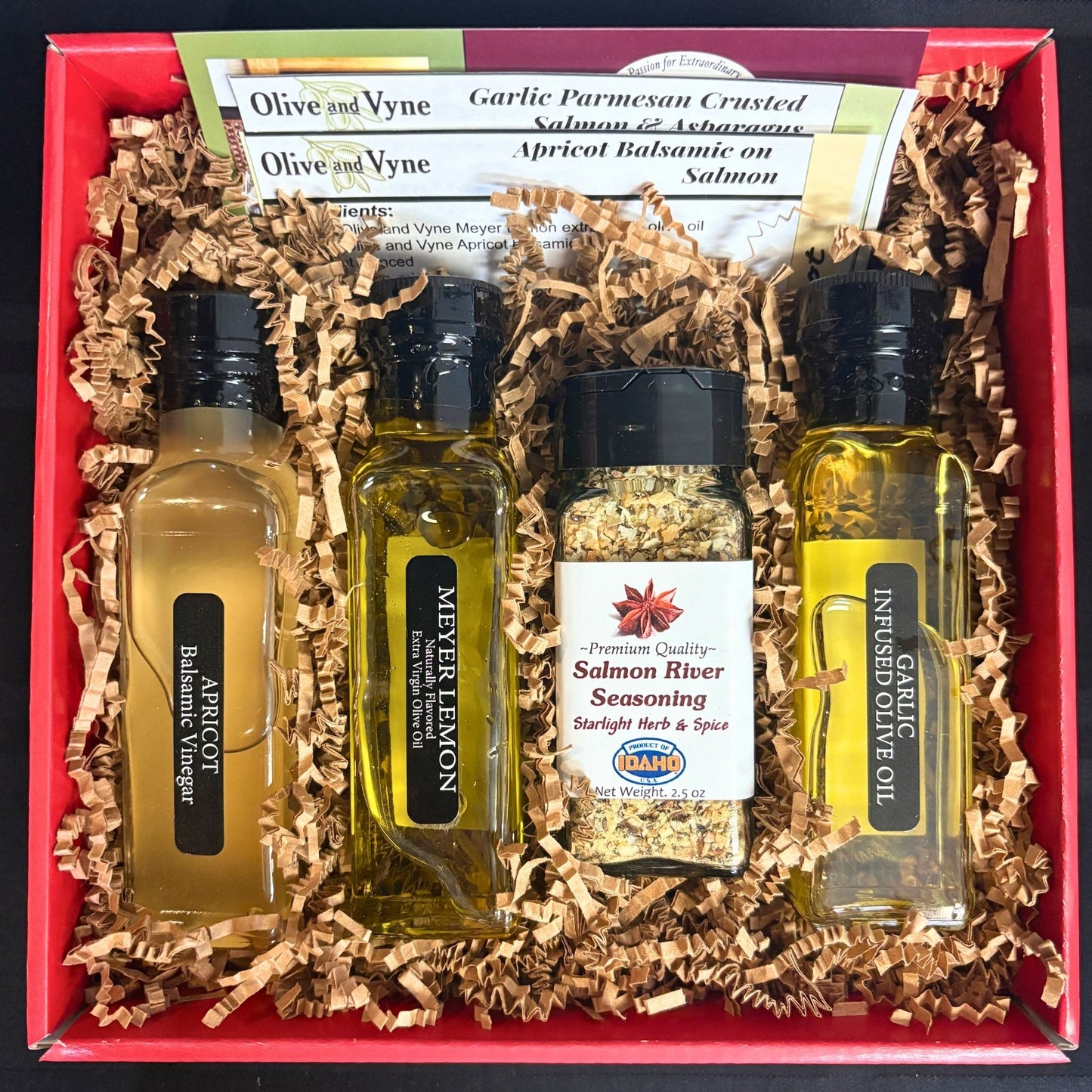 Open Salmon Lovers Gift Box showing Apricot Balsamic, Meyer Lemon EVOO, Garlic EVOO, Salmon River Seasoning, and recipe cards
