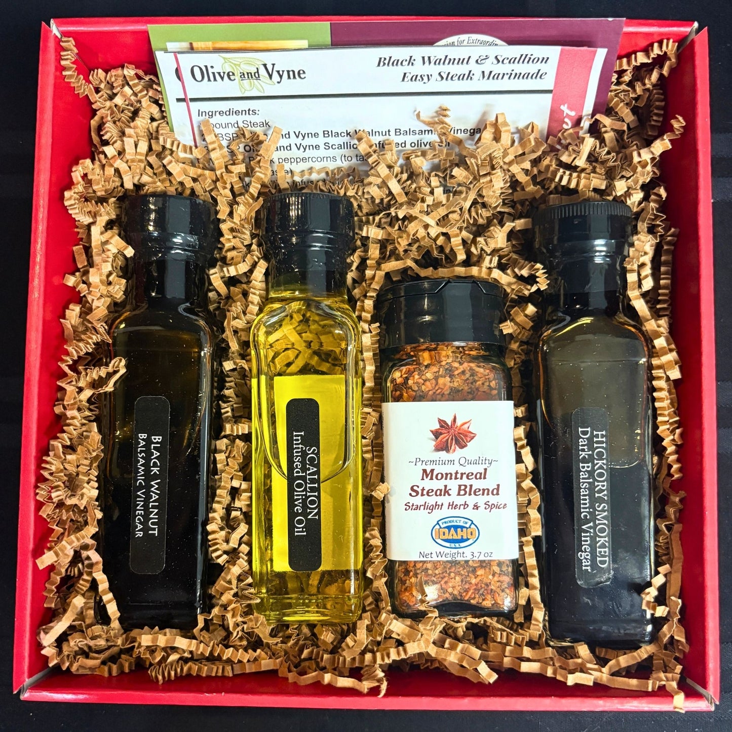 Open Steak Lovers Gift Box showing Black Walnut and Hickory Smoked balsamics, Scallion olive oil, Montreal Steak Blend, and recipe cards